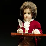 The Jaquet-Droz Writer automaton, an 18th-century mechanical figure that writes with a quill pen, on display at a museum