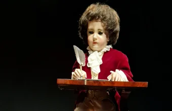 The Jaquet-Droz Writer automaton, an 18th-century mechanical figure that writes with a quill pen, on display at a museum