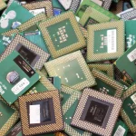 A dense pile of discarded Intel Pentium III and Celeron computer processors awaiting recycling
