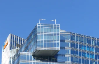 Akamai's glass headquarters tower in Cambridge, Massachusetts, with the company's logo visible on the facade