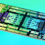 Microscope die shot of an AMD EPYC 7702 engineering sample I/O die, its circuit blocks glowing in teal, gold and violet