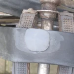 A round rubber patch applied to a punctured bicycle inner tube