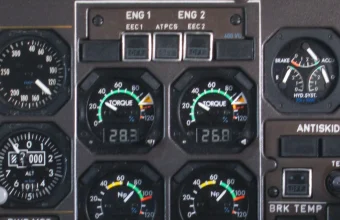 Close-up of a real aircraft cockpit engine instrument panel with dense analog gauges, used as a visual metaphor for application instrumentation