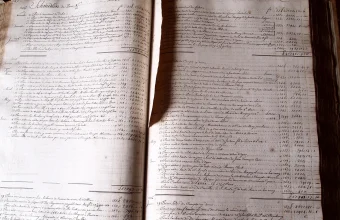An open 18th-century accounting ledger book showing handwritten rows and columns of numbers in ink