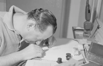A jeweler examining diamonds through a loupe while sorting them on a desk in 1964