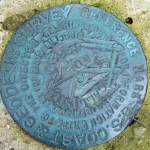 A US National Geodetic Survey reference marker set in the ground, an immutable physical reference point