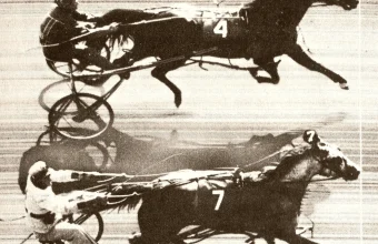 A 1953 photo finish camera image showing two harness racing horses and jockeys nearly overlapping at the finish line