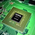 Macro photo of a bare NVIDIA GPU chip mounted on a green circuit board