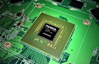 Macro photo of a bare NVIDIA GPU chip mounted on a green circuit board
