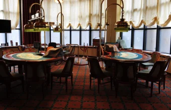 Two empty blackjack tables inside a European casino, evoking the multi-agent blackjack scenario researchers used to test AI collusion detection