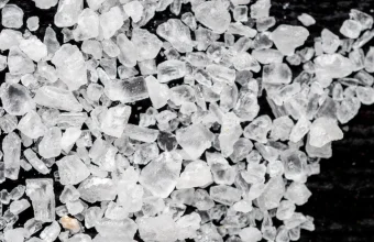 Macro photo of coarse sea salt crystals, a visual metaphor for salting password hashes