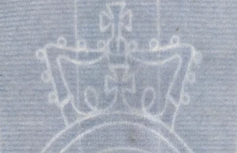 Faint white watermark of a crown above an oval emblem showing through blue paper, a design that stays invisible until light passes through the sheet