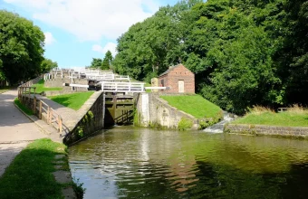 A staircase of sequential canal lock chambers at Bingley Five Rise Locks, each gate validating the water level before the next stage