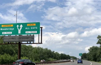 A green highway sign splitting into an EXPRESS lane and a LOCAL lane, the same express-lane idea a skip list uses to skip ahead through sorted data