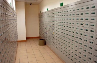 A hallway lined with hundreds of individually numbered post office boxes at a Hong Kong post office