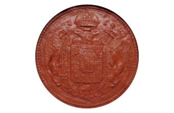 A red wax seal from 1810 bearing an ornate coat of arms, crown, and heraldic supporters, photographed on a plain white background