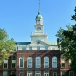 Fuld Hall's clock tower rising above trees at the Institute for Advanced Study in Princeton, where OpenAI's new mathematics advisory group is hosted