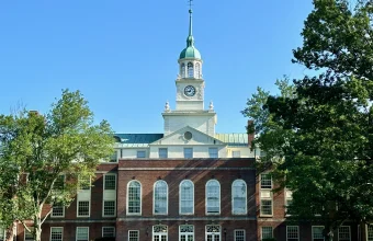 Fuld Hall's clock tower rising above trees at the Institute for Advanced Study in Princeton, where OpenAI's new mathematics advisory group is hosted