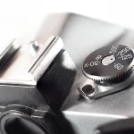 Macro photo of a vintage film camera's shutter speed dial and hot shoe, used as a general photography visual for a story about a flaw in an image-decoding library