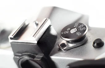 Macro photo of a vintage film camera's shutter speed dial and hot shoe, used as a general photography visual for a story about a flaw in an image-decoding library