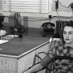 1945 black-and-white photograph of a polygraph lie detector test, with an examiner writing notes at a desk while a seated woman is wired to the machine