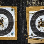 Red Hat’s RHEL 10 STIG Update Turns Compliance Into a Moving Target Two well-worn paper archery targets riddled with arrow holes, mounted on cardboard backing at an outdoor range
