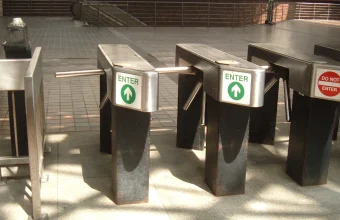 Subway turnstiles showing a green ENTER sign and a red DO NOT ENTER sign side by side