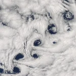 Satellite photo of a chain of spiral cloud vortices trailing downwind of Heard Island in the southern Indian Ocean