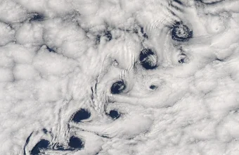 Satellite photo of a chain of spiral cloud vortices trailing downwind of Heard Island in the southern Indian Ocean