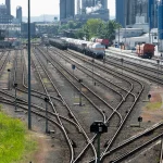 Classification yard at Godorf in Cologne, Germany, with dozens of numbered tracks fanning out and rejoining through switches beside an industrial plant