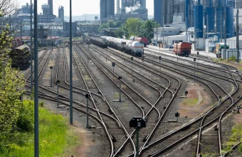 Classification yard at Godorf in Cologne, Germany, with dozens of numbered tracks fanning out and rejoining through switches beside an industrial plant