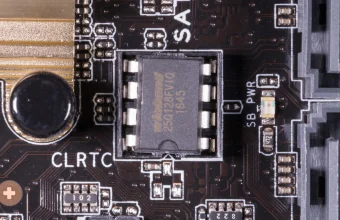 A socketed 8-pin SPI flash chip on a motherboard, the kind of part that holds UEFI firmware, beside the CLRTC and SB PWR markings