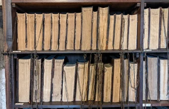 Shelves of old books fastened by iron chains in the Francis Trigge Chained Library in Grantham, England, a picture of data that can be read but not changed