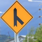 GitHub’s Git Rebuild Turns Repository Durability and Read Scale Into Two Separate Problems Yellow diamond-shaped merging traffic warning sign showing a side road joining a main road