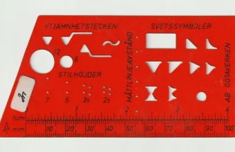Red 1970s drafting stencil with cut-out symbols and a ruler edge, standing in for a prompt template
