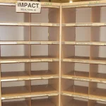 Empty wooden mail sorting frame with rows of labeled pigeonholes, like a row of boxes standing in for a memory buffer