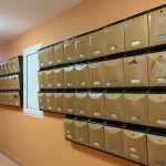 How to Prevent Broken Object Level Authorization (IDOR) in a FastAPI App Rows of identical brass-colored apartment mailboxes with small locks and name labels along an orange corridor wall