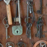 A wooden board hung with dozens of old keys on rings and key tags