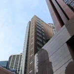 Singapore’s AI Guidelines Turn Independent Review Into a Question of Who Sets the Risk Rating Street-level upward view of the Monetary Authority of Singapore building and neighbouring office towers under a pale sky
