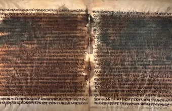Two opened leaves of the Verona palimpsest, with an older, darker layer of writing still showing through the newer script written over it