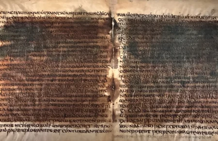 Two opened leaves of the Verona palimpsest, with an older, darker layer of writing still showing through the newer script written over it
