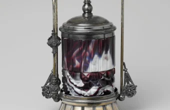 Victorian silver-framed glass pickle jar with a swirled purple and white body and a domed lid against a grey background