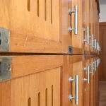 Rows of numbered wooden lockers with metal handles, with plates 193 and 194 in the foreground