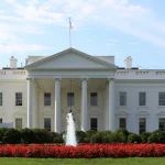 North facade of the White House in Washington, D.C., with the fountain and red flower beds in the foreground