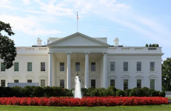 North facade of the White House in Washington, D.C., with the fountain and red flower beds in the foreground